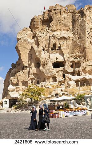 Three young women walk on the road with Uchisar Castle in the background; Uchisar, Cappadocia, Turkey View Large Photo Image Stock Photo - Three young women walk on the road with Uchisar Castle in the background; Uchisar, Cappadocia, Turkey. Fotosearch