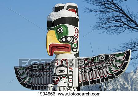 Thunderbird House Post Carved In Kwakiutl Style By Tony Hunt Covered In Snow In Stanley Park, Vancouver, British Columbia, Canada View Large Photo Image Stock Photograph - Thunderbird House Post Carved In Kwakiutl Style By Tony Hunt Covered In Snow In Stanley Park, Vancouver, British Columbia, Canada. Fotosearch