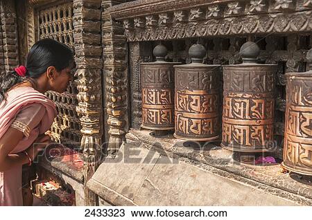 Tibetan rolls, a woman watching inside buddhist deity, Swayambhu Temple; Kathmandu, Nepal View Large Photo Image Stock Image - Tibetan rolls, a woman watching inside buddhist deity, Swayambhu Temple; Kathmandu, Nepal. Fotosearch