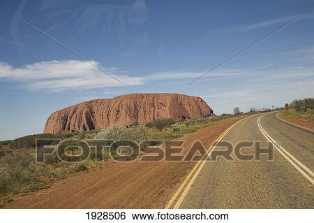 Stock Photograph - Tilted Angle View Of Ayers Rock And Nearby Road, Northern Territory, Australia. Fotosearch