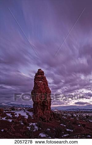 Stock Photo - Timed Exposure Of Sunset Clouds Over Pinnacle In Arches National Park, Utah.. Fotosearch