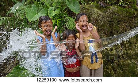 Timorese children playing with water; Timor-Leste View Large Photo Image Stock Image - Timorese children playing with water; Timor-Leste. Fotosearch