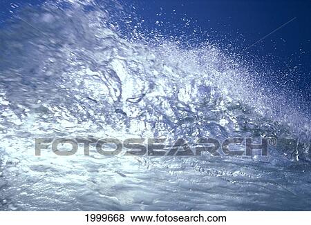 Stock Photo - Tip Of Clear Wave With Sunlight Shining Through, Blue Sky C1736. Fotosearch