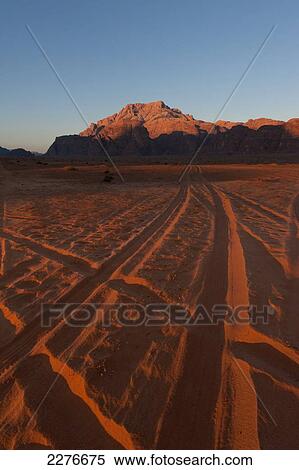 Stock Photography - Tire tracks in the desert; Wadi Rum, Jordan. Fotosearch