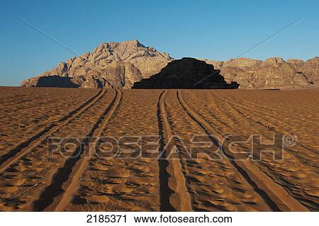 Stock Image - Tire Tracks In The Early Morning, Wadi Rum, Jordan, Middle East. Fotosearch