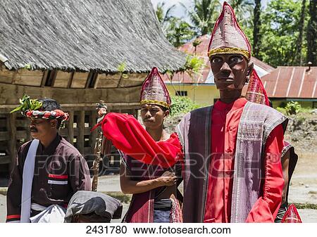 Toba Batak people performing a Sigale Gale puppet dance with a life-sized wooden puppet standing on a platform at Huta Bolon Museum in Simanindo village on Samosir Island, Lake Toba, North Sumatra, Indonesia View Large Photo Image Stock Image - Toba Batak people performing a Sigale Gale puppet dance with a life-sized wooden puppet standing on a platform at Huta Bolon Museum in Simanindo village on Samosir Island, Lake Toba, North Sumatra, Indonesia. Fotosearch