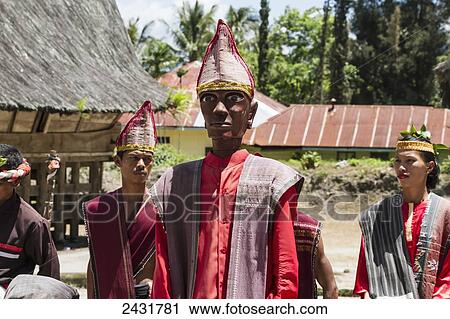 Stock Image - Toba Batak people performing a Sigale Gale puppet dance with a life-sized wooden puppet standing on a platform at Huta Bolon Museum in Simanindo village on Samosir Island, Lake Toba, North Sumatra, Indonesia. Fotosearch