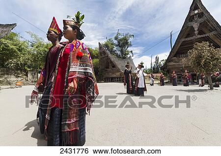 Stock Photograph - Toba Batak people performing a traditional Batak dance at Huta Bolon Museum in Simanindo village on Samosir Island, Lake Toba, North Sumatra, Indonesia. Fotosearch