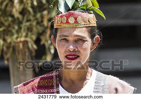 Stock Photo - Toba Batak woman in traditional costume at Huta Bolon Museum in Simanindo village on Samosir Island, Lake Toba, North Sumatra, Indonesia. Fotosearch