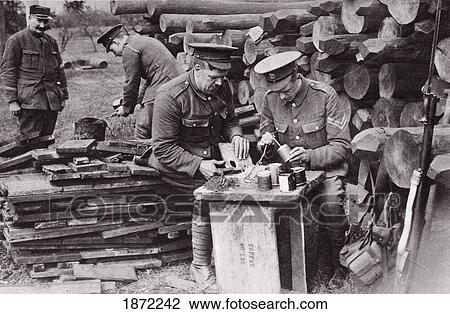 Stock Image - Tobacco Tins As Hand Grenades. Men Of The Royal Engineers Loading Reserve Stocks In Rear Of The Trenches During The First World War. From The Illustrated War News Published 1915. Fotosearch