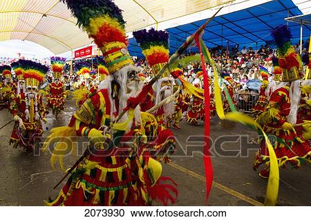 Stock Image - Tobas Dancers Wearing Elaborate Masks, Feather Headdresses And Costumes In The Procession Of The Carnaval De Oruro, Oruro, Bolivia. Fotosearch