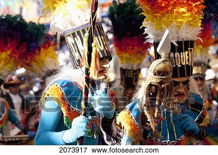 Stock Photo - Tobas Dancers Wearing Elaborate Masks, Feather Headdresses And Costumes In The Procession Of The Carnaval De Oruro, Oruro, Bolivia. Fotosearch