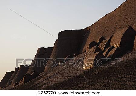 Stock Image - Tombs on city walls around Ichan Kala Old City, Khiva, Khwarezm, Uzbekistan. Fotosearch
