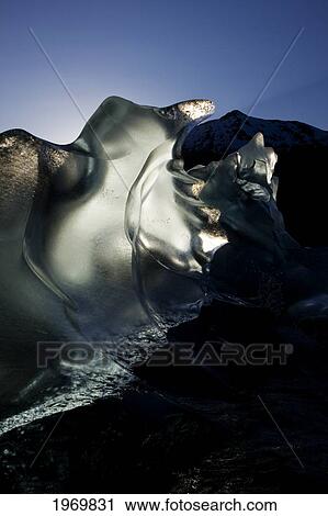 Stock Image - Tongass Forest, Alaska, Recently Calved From The Terminus Of Mendenhall Glacier In Mendenhall Lake, An Iceberg Transmits The Light From The Setting Sun.. Fotosearch