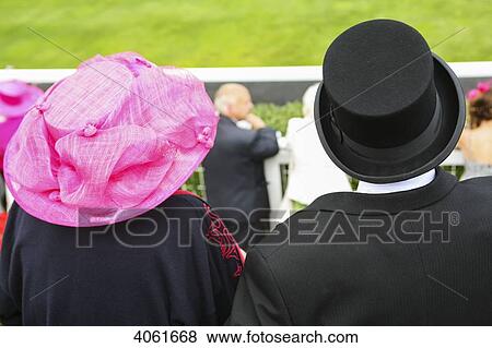 Stock Photo - Top hat and dressed up at parade ring during Royal Ascot horse racing meeting; Berkshire, England. Fotosearch