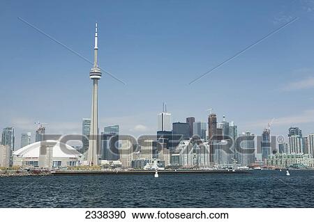 Stock Image - Toronto Skyline From Lake Ontario With Blue Sky And Clouds; Toronto, Ontario, Canada. Fotosearch