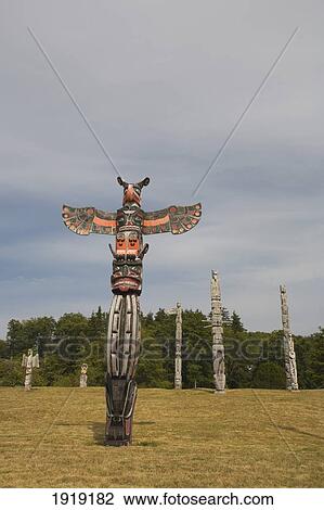 Stock Image - Totem Poles In The Namgis Burial Grounds; Alert Bay, Cormorant Island, British Columbia, Canada. Fotosearch