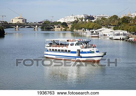 Tour Boat Along The Guadalquivir River; Seville Spain View Large Photo Image Stock Image - Tour Boat Along The Guadalquivir River; Seville Spain. Fotosearch