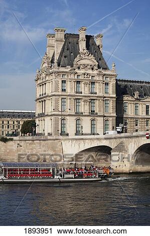 Tour Boat Along The River With A Building And Bridge In The Background; Paris, France View Large Photo Image Stock Image - Tour Boat Along The River With A Building And Bridge In The Background; Paris, France. Fotosearch