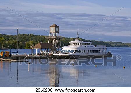 Stock Photo - Tour Boat On Lac Memphremagog And An Observation Tower On A Pier; Magog, Quebec, Canada. Fotosearch