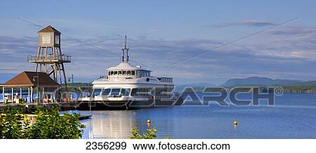 Stock Photo - Tour Boat On Lac Memphremagog And An Observation Tower On A Pier; Magog, Quebec, Canada. Fotosearch
