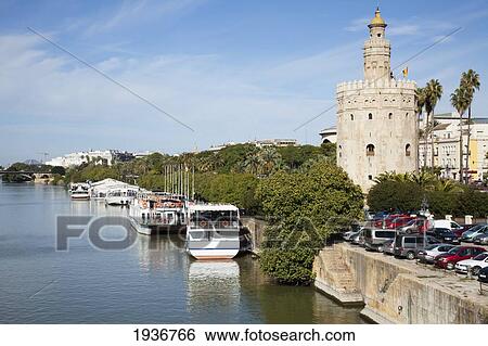Stock Photograph - Tour Boats Along The Guadalquivir River; Seville Spain. Fotosearch