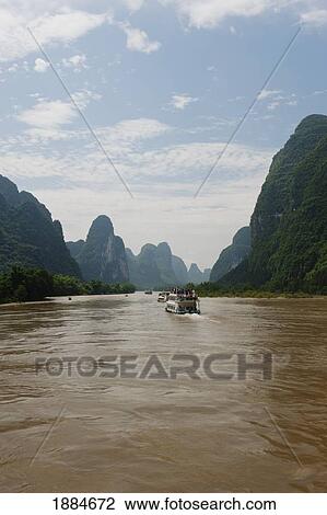 Tour Boats On River Li Near Yangshuo, With Karst Formations In The Background; Guilin, Guangxi, China View Large Photo Image Stock Image - Tour Boats On River Li Near Yangshuo, With Karst Formations In The Background; Guilin, Guangxi, China. Fotosearch