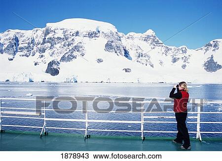 Stock Image - Tourist Admires View In The Neumayer Channel. Fotosearch