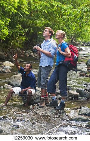 Stock Image - Tourist birdwatchers; West New Britain, Papua New Guinea. Fotosearch