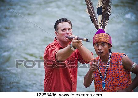 Tourist blowing blowpipe at Ulu Ulu National Park Resort; Brunei View Large Photo Image Stock Photograph - Tourist blowing blowpipe at Ulu Ulu National Park Resort; Brunei. Fotosearch