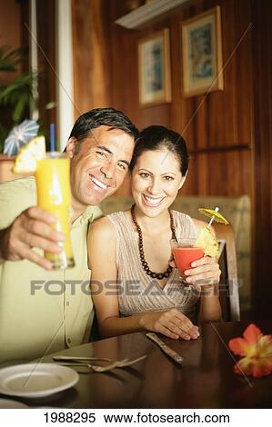 Tourist Couple At A Bar Enjoying Cocktails Smile For Camera View Large Photo Image Stock Photography - Tourist Couple At A Bar Enjoying Cocktails Smile For Camera. Fotosearch