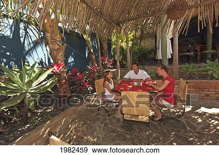 Stock Photo - Tourist Family Sitting Together At Hotel California; Todos Santos Baja California Sur Mexico. Fotosearch