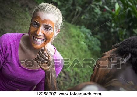 Tourist getting her face painted; Santo Island, Vanuatu View Large Photo Image Stock Photo - Tourist getting her face painted; Santo Island, Vanuatu. Fotosearch