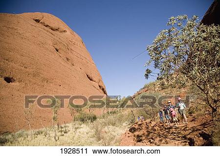 Stock Image - Tourist Group Exploring The Olgas, Kata Tjuta, Northern Territory, Australia. Fotosearch