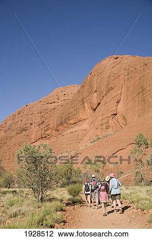 Stock Image - Tourist Group Exploring The Olgas, Kata Tjuta, Northern Territory, Australia. Fotosearch