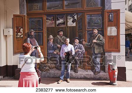 Tourist having photo taken next to wall mural of famous pioneering mountain climbers in centre of Chamonix-Mont Blanc; Chamonix, Mont Blanc Valley, France View Large Photo Image Stock Photo - Tourist having photo taken next to wall mural of famous pioneering mountain climbers in centre of Chamonix-Mont Blanc; Chamonix, Mont Blanc Valley, France. Fotosearch