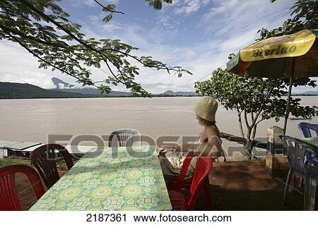 Tourist in riverside cafe along the Mekong river; Pakse, Champasak Province, Laos View Large Photo Image Stock Image - Tourist in riverside cafe along the Mekong river; Pakse, Champasak Province, Laos. Fotosearch
