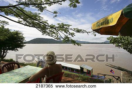 Tourist in riverside cafe along the Mekong river; Pakse, Champasak Province, Laos View Large Photo Image Stock Photography - Tourist in riverside cafe along the Mekong river; Pakse, Champasak Province, Laos. Fotosearch
