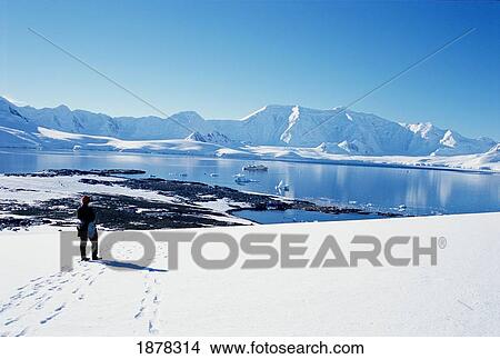 Tourist In Snow Overlooking Landscape Of Wiencke Island View Large Photo Image Picture - Tourist In Snow Overlooking Landscape Of Wiencke Island. Fotosearch