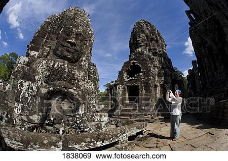 Stock Photo - Tourist In The Ruins Of Bayon Temple In Ancient City Of Angkor; Angkor Wat, Siem Reap, Cambodia. Fotosearch
