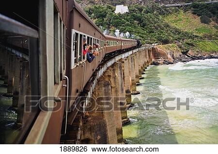 Stock Photograph - Tourist In Windows Of Steam Train On Kaaimans Bridge. Fotosearch