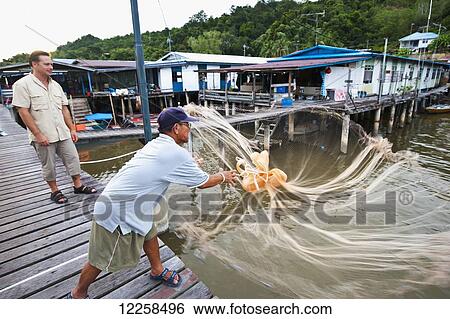 Tourist learning net fishing at a small village; Brunei View Large Photo Image Stock Photograph - Tourist learning net fishing at a small village; Brunei. Fotosearch