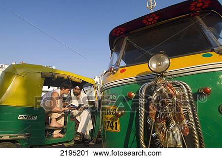 Tourist Looking At Guide Book With Sikh Rickshaw Driver, Delhi, India. View Large Photo Image Stock Image - Tourist Looking At Guide Book With Sikh Rickshaw Driver, Delhi, India.. Fotosearch