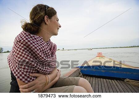 Stock Image - Tourist Looking For Irrawaddy Dolphins During A Boat Trip.. Fotosearch