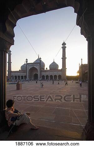 Stock Photograph - Tourist Looking Over The Main Courtyard Of The Jami Masjid At Dusk. Fotosearch