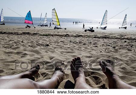 Tourist On Beach With Sail Buggies Passing In The Background View Large Photo Image Picture - Tourist On Beach With Sail Buggies Passing In The Background. Fotosearch