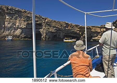 Stock Image - Tourist On Boat Coming Into Blue Lagoon. Fotosearch