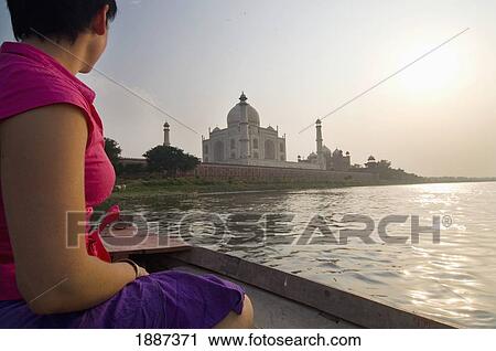 Stock Image - Tourist On Boat Crossing The Yamuna River At Dusk By The Taj Mahal. Fotosearch