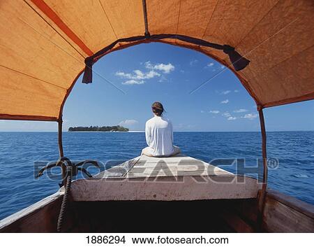 Tourist On Bow Of Motorized Dhow Heading Out To Prison Island View Large Photo Image Picture - Tourist On Bow Of Motorized Dhow Heading Out To Prison Island. Fotosearch