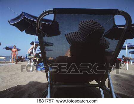 Stock Photo - Tourist On Sun Lounger On Beach. Fotosearch